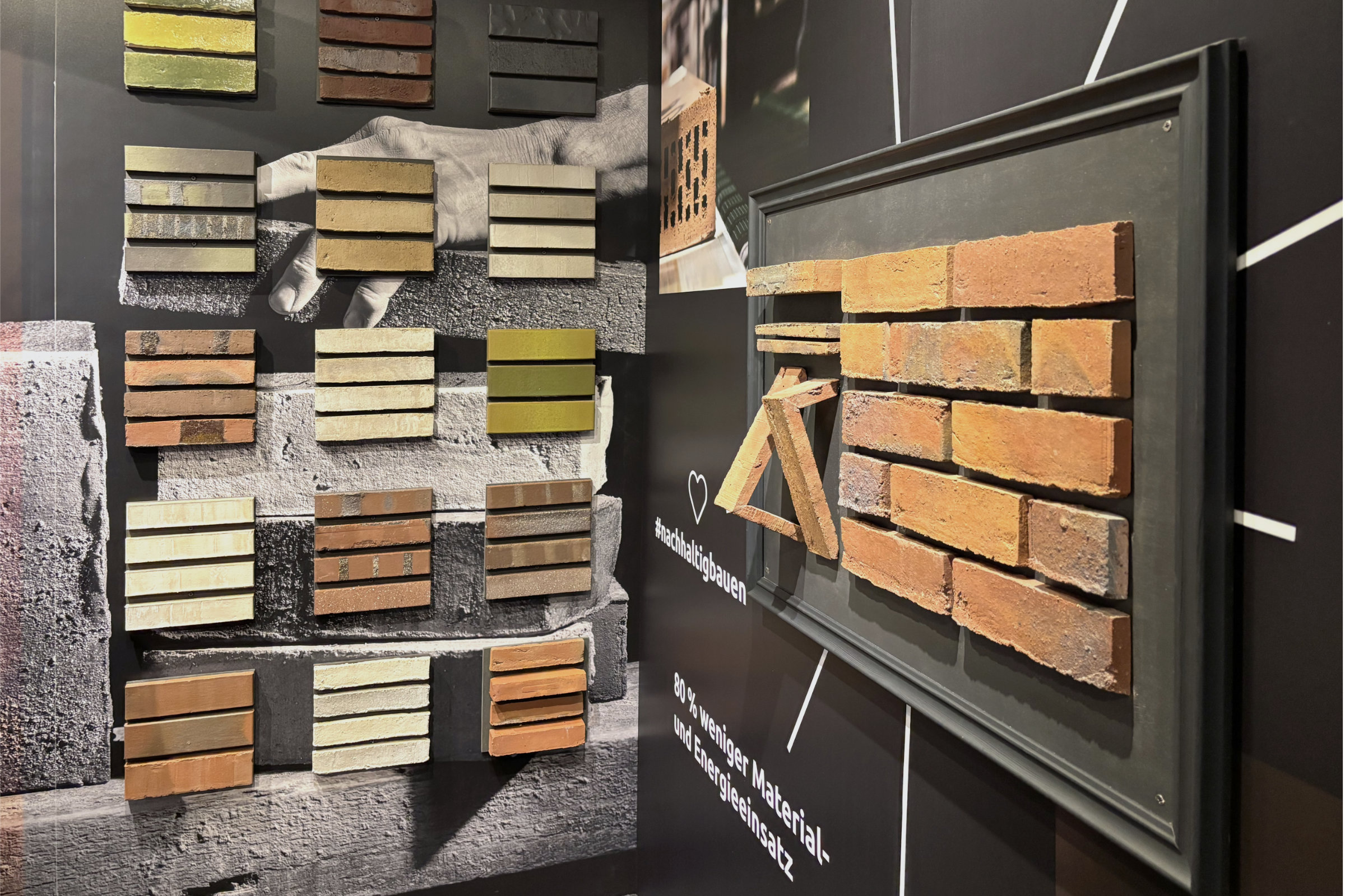 Messestand auf der architect@work mit farblich sortierten Klinkersteinen und dem Hinweis auf 80 % weniger Material- und Energieeinsatz