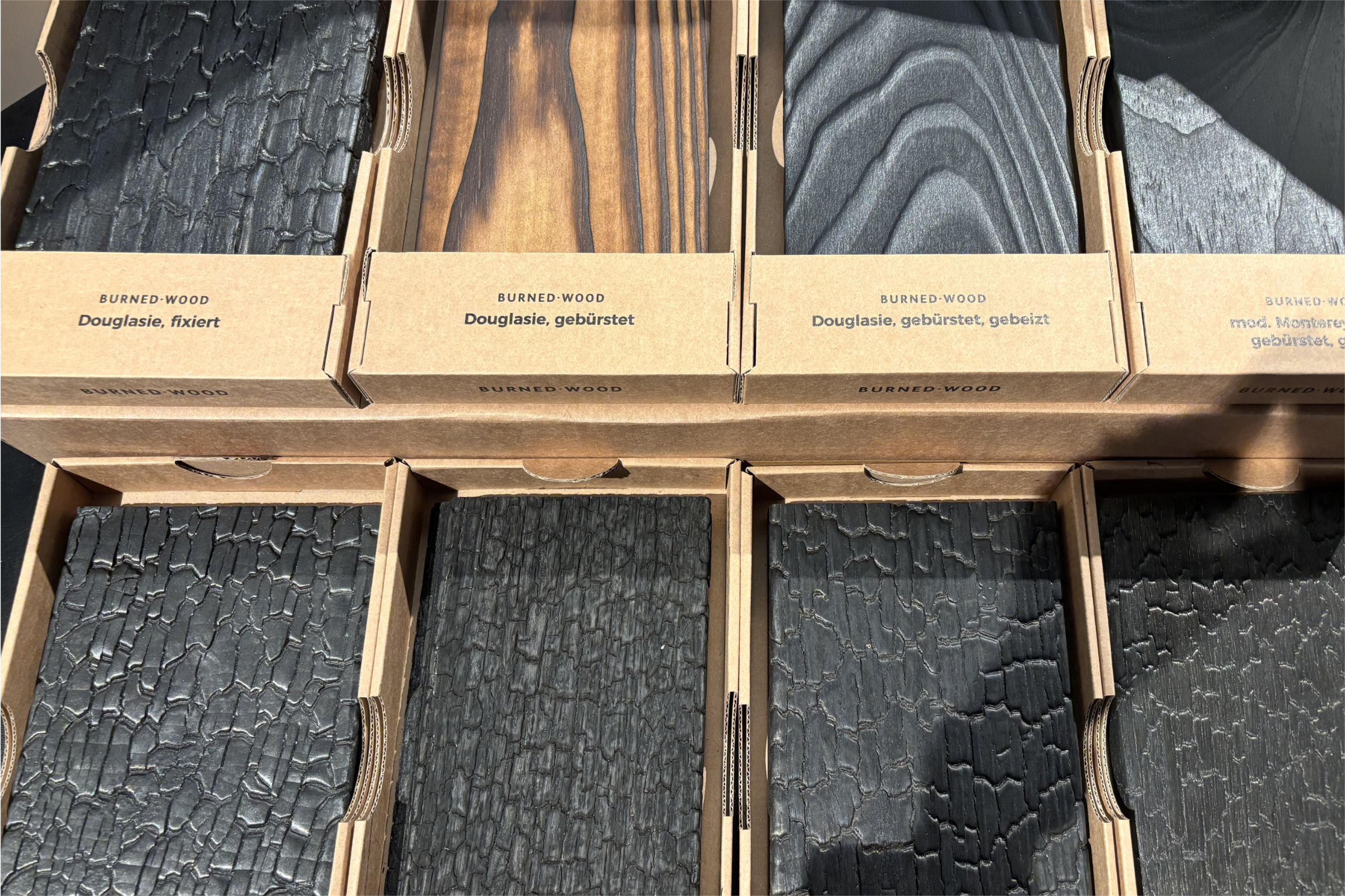 JPA_Aktuelles_architectatwork_3 Materialmuster aus gebranntem Holz („Burned Wood“) mit verschiedenen Oberflächen auf der architect@work
